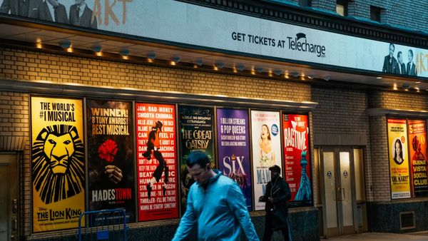 People walk past a Broadway theater in Times Square on October 21, 2025, in New York City. Zamek/VIEWpress/Corbis News/Getty Images